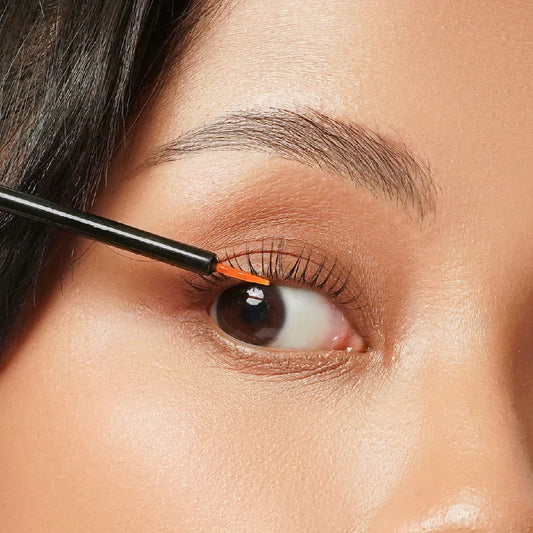 Model menggunakan produk lash brow serum di area mata